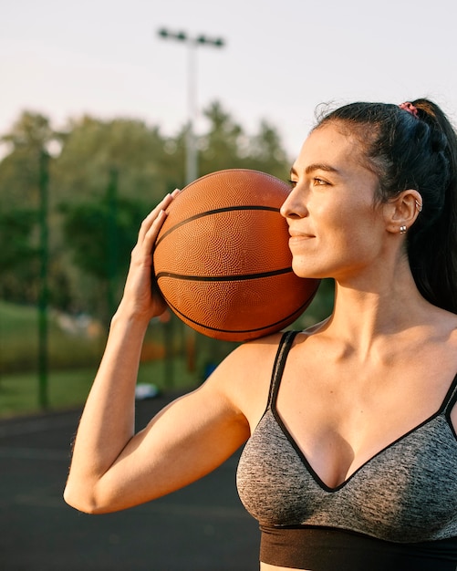 Young woman playing basketball alone