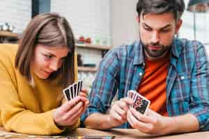 Free photo young woman playing the cards at home