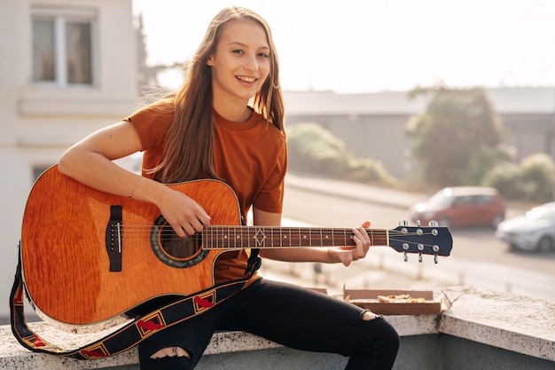 Young woman playing the guitar