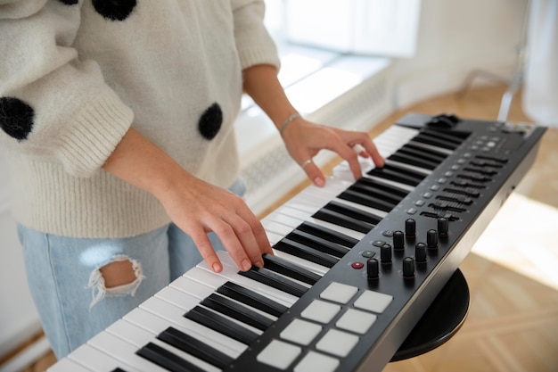 Young woman playing the piano indoors