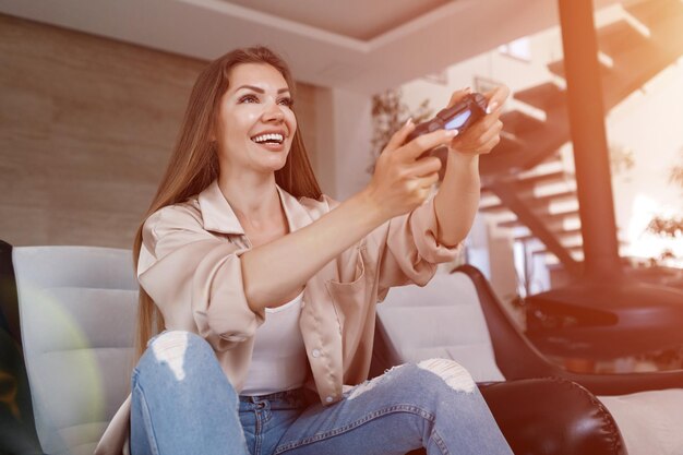 young woman playing playstation at home