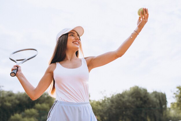 Young woman playing tennis at the court