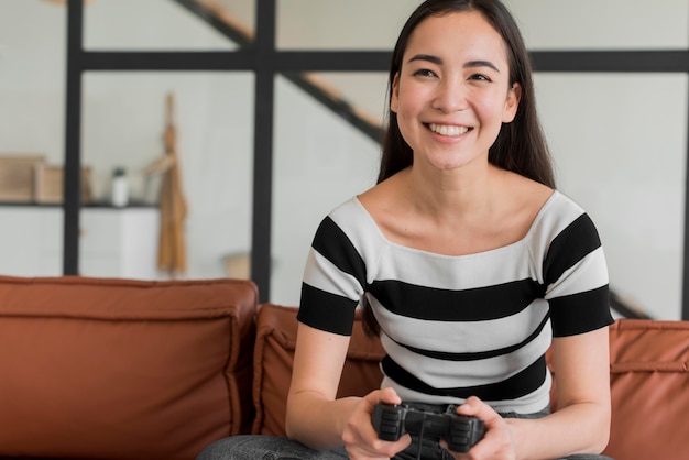 Free photo young woman playing with joystick