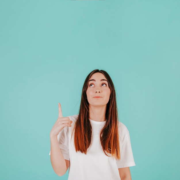 Young woman pointing up