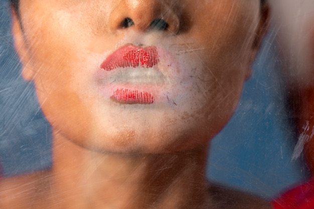 Young woman portrait behind plastic wrap