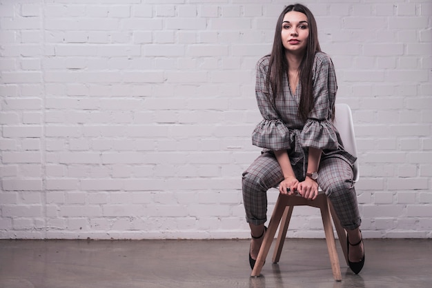 Free Photo young woman posing on chair