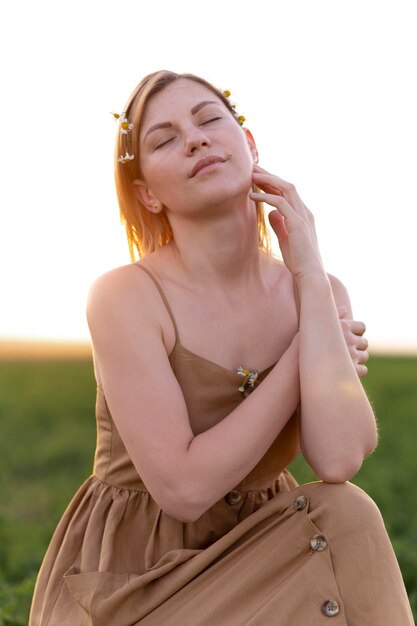 Young woman posing outdoors in a field