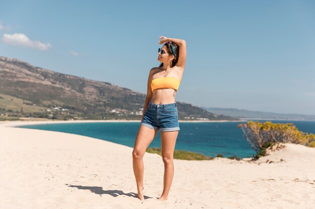 Young woman posing on sandy beach