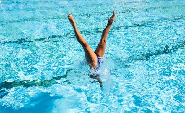 Young woman posing at the swimming pool