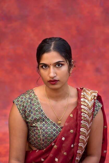 Young woman posing while wearing traditional sari garment