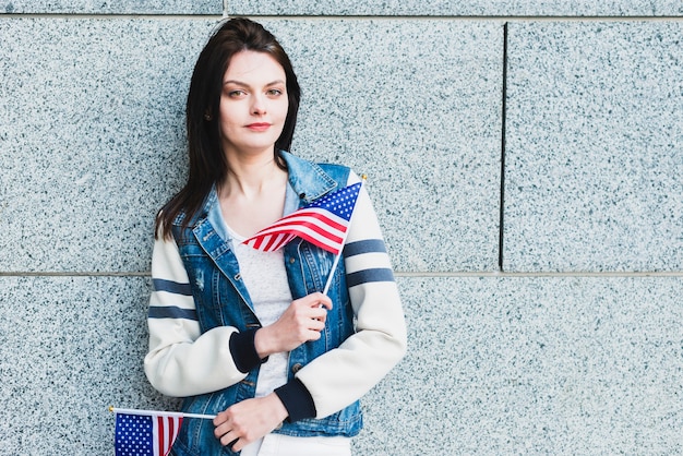 Young woman posing with American flags