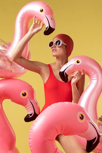 Young woman posing with flamingo swimming ring