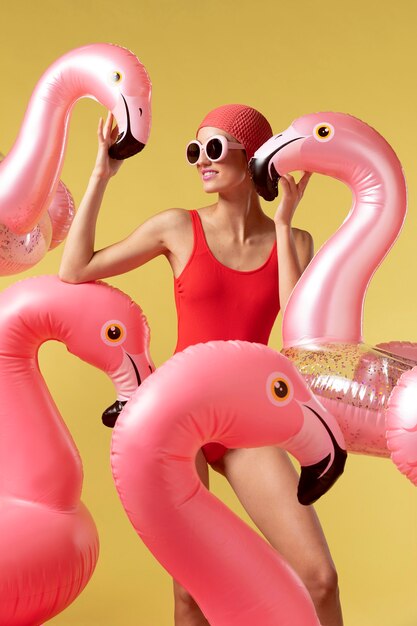 Young woman posing with flamingo swimming ring