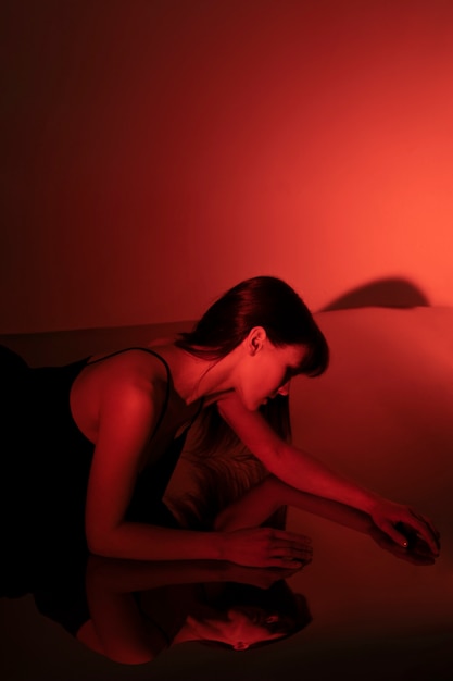 Young woman posing with mirror reflection