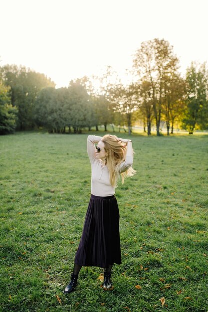 Young Woman Posing Over Yellow Leaves In The Autumn Park. Outdoor