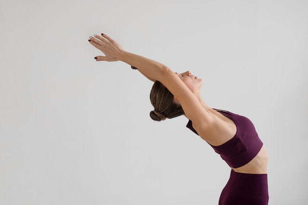 Free Photo young woman practicing yoga for her body balance