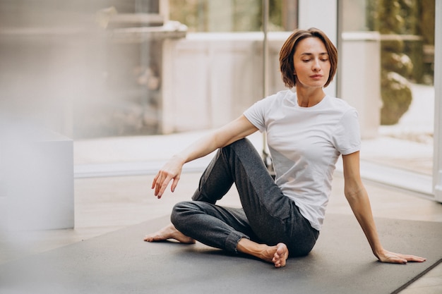 Young woman practicing yoga at home