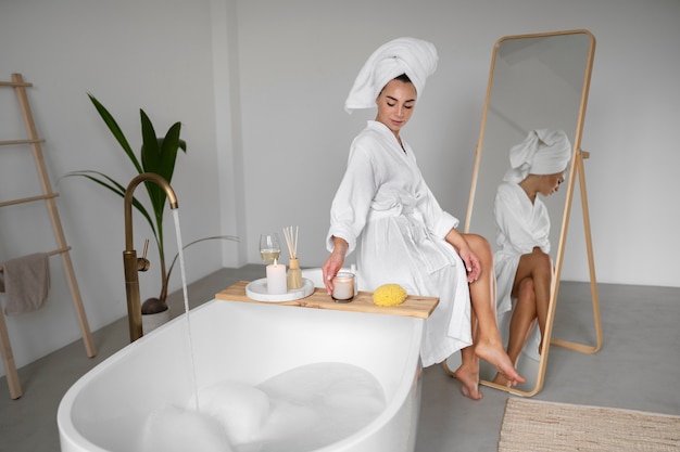 Free photo young woman preparing for her bath time