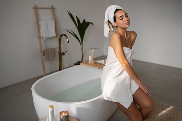 Young woman preparing for her bath time