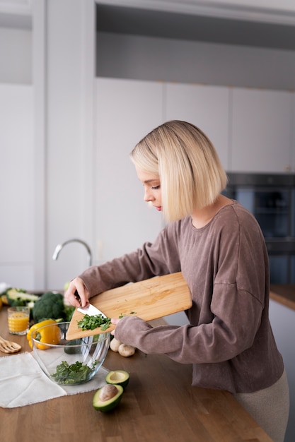 Free photo young woman preparing her nutrition diet