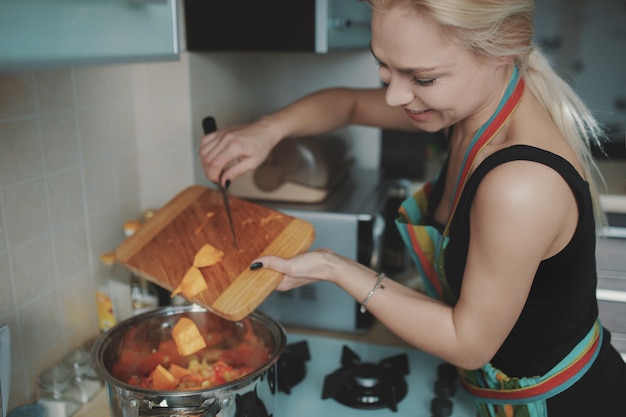 Free photo young woman preparing pumpkin soup