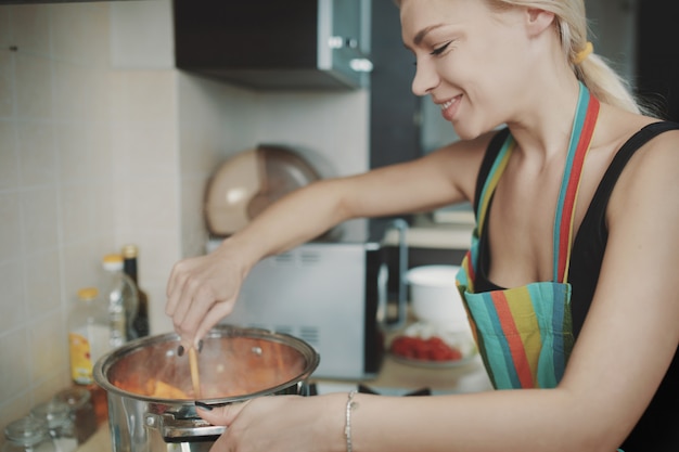 Young woman preparing pumpkin soup