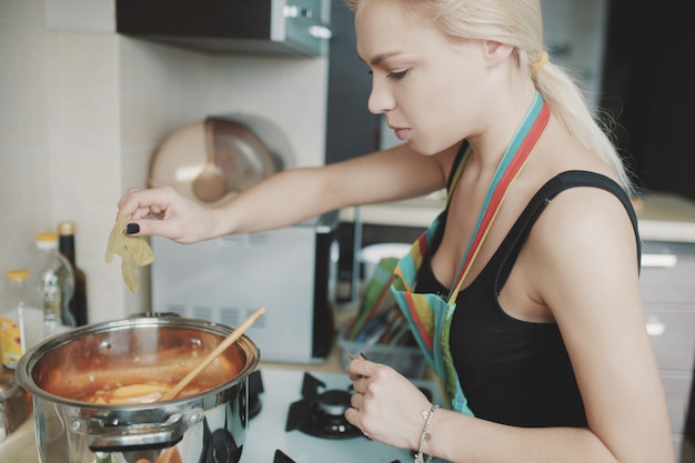 Free photo young woman preparing pumpkin soup