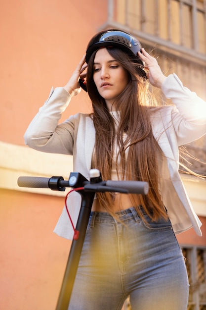 Young woman preparing to ride in a electrical scooter in the city