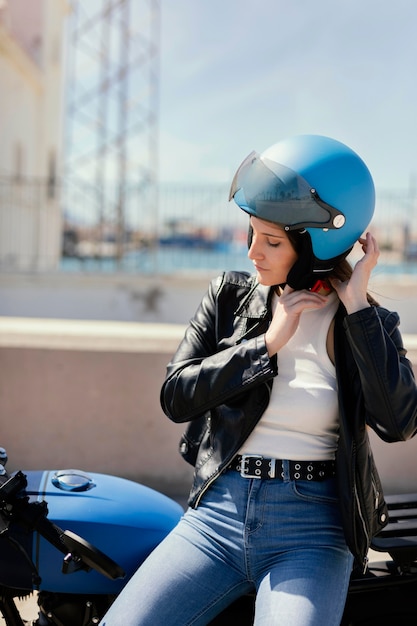 Young woman preparing to ride in a motorcycle in the city