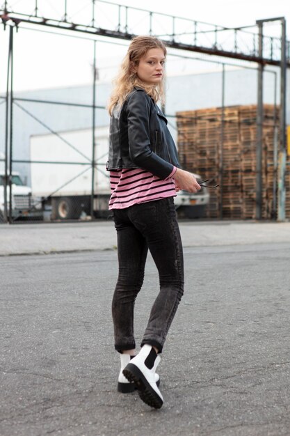 Young woman in punk clothes outdoors