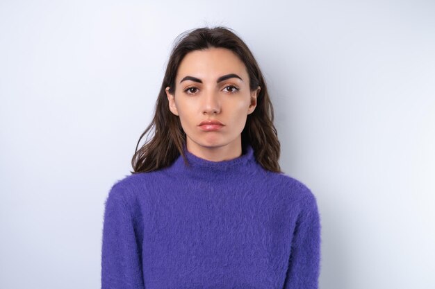 Young woman in purple soft cozy sweater in the background upset