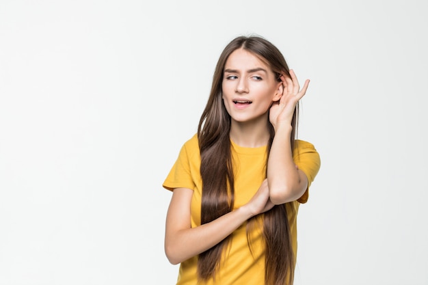 Young woman reaction on something heard isolated over white wall