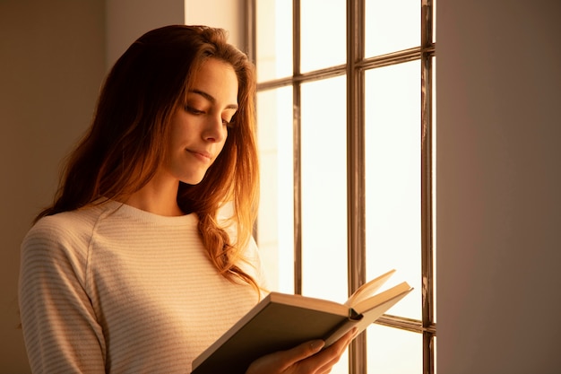 Young woman reading a book at home