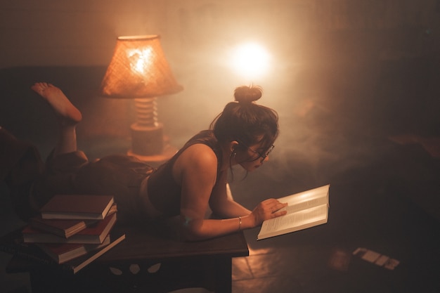 Young woman reading a book at home