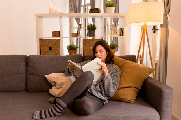 Young woman reading in the living room