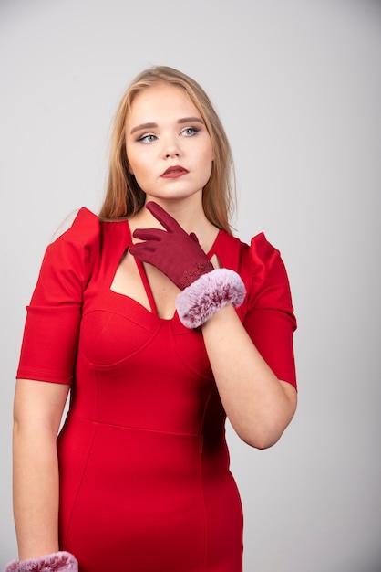 Young woman in red dress looking at somewhere. 