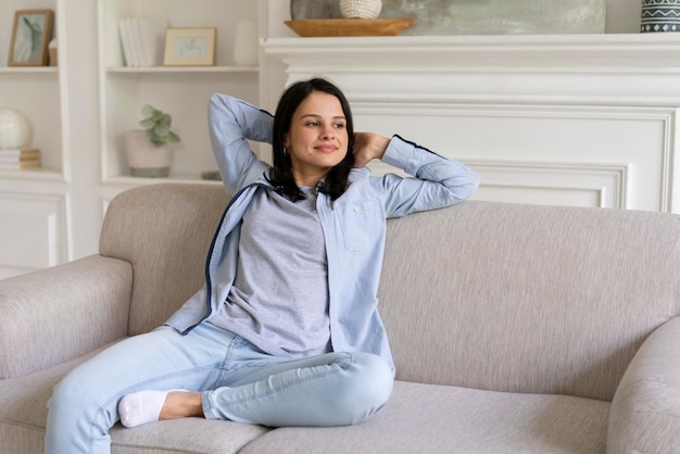 Free photo young woman relaxing on the couch