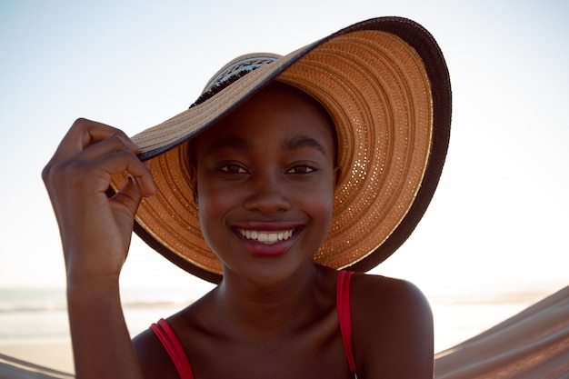 Young woman relaxing in a hammock on the beach