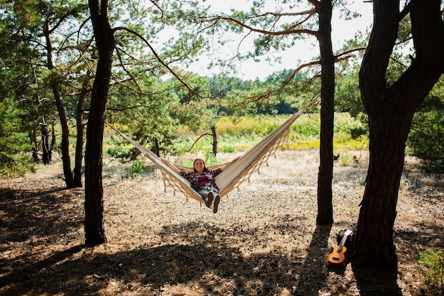 Free Photo young woman relaxing in hammock