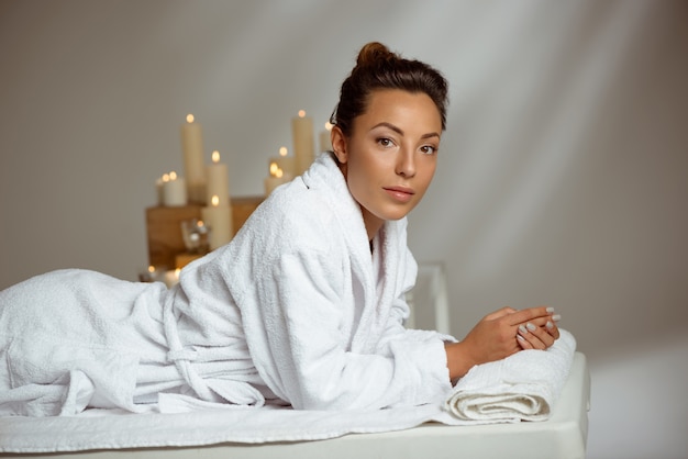 Young woman relaxing in spa salon.