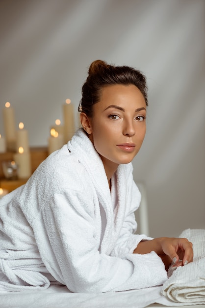 Young woman relaxing in spa salon.