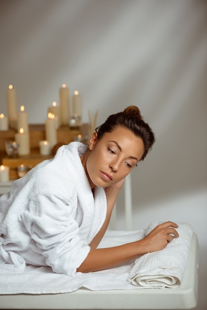 Young woman relaxing in spa salon.