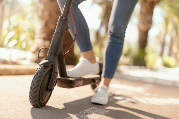 Young woman rides in a electrical scooter in the city