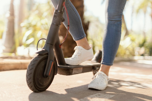 Young woman rides in a electrical scooter in the city