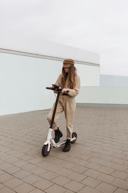 Free Photo young woman riding an electric scooter