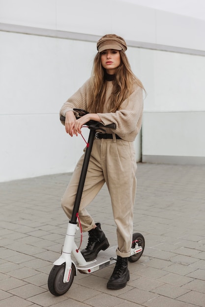 Free photo young woman riding an electric scooter