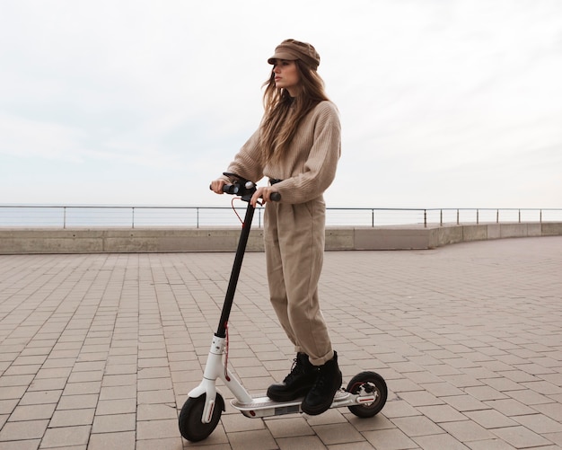 Young woman riding an electric scooter