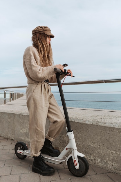 Young woman riding an electric scooter