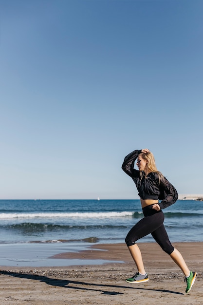 Young woman running at the beach