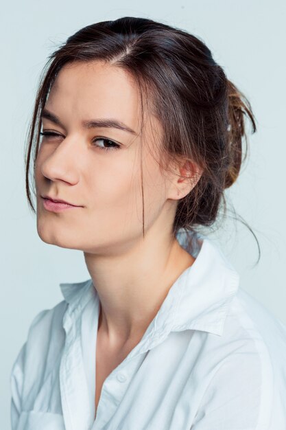 The young woman's portrait with thoughtful emotions on blue space